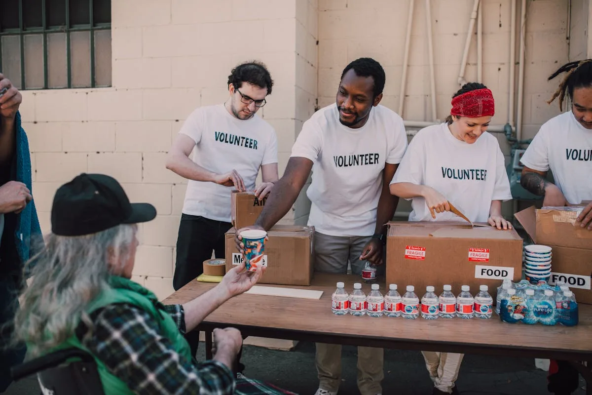 Volunteers distributing donations at outdoor community charity event - 100 Kids Who Care Quinte