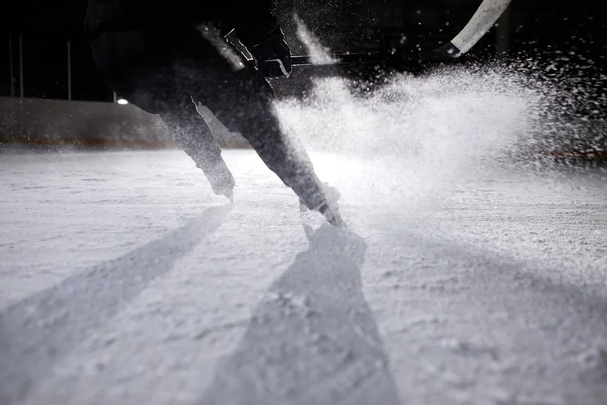 Ice hockey player creating dramatic ice spray during fast skating - AHL All-Star hardest shot Belleville Senators